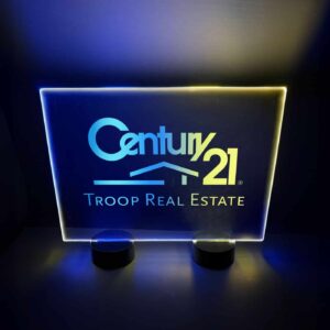 Bright LED acrylic sign for Century 21 real estate, showcasing blue and yellow lights designed for table display