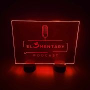 A red LED acrylic sign showcasing an engraved design for a podcast