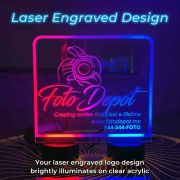 Laser-engraved branding on a lighted display sign, showcasing the etched design and illuminated effects