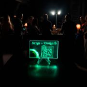 Scan to donate QR code on a light up acrylic card display