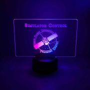 A custom light up table display with dual-color LED lights, featuring a custom-engraved logo for the simulator control