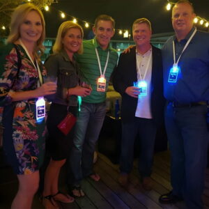 Group of five professional adults at networking event wearing LED name badges
